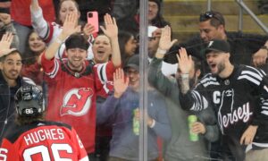 new jersey devils fans celebrate jack hughes goal