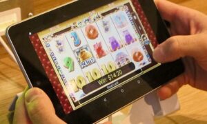 image of user playing resorts online casino in new jersey for story on nj online casinos driving record tax collection