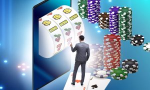 man plays slot machine on tablet for a story on december 2023 revenue by new jersey online casinos