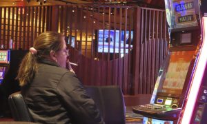 Photo of woman smoking at Ocean Casino in NJ, where Sen. John Burzichelli has proposed a compromise to the smoking ban bill