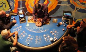 Ocean Casino Resort dealer with players for a story on the February 2024 revenue generated by Atlantic City casinos