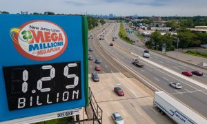 Billboard with Mega Millions jackpot prize for a story on a New Jersey Lottery ticket claiming the $1.128 billion jackpot