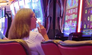 Woman smokes while playing slots at Hard Rock Atlantic City for a story on a labor union and the New Jersey attorney general urging the court to dismiss a smoking ban lawsuit