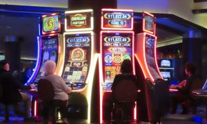 Gamblers play slots at Harrah's Atlantic City for a story on March 2024 revenue reported by casinos in Atlantic City