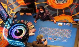 Dealer works a table at Ocean Casino Resort for a story on Atlantic City casino workers suing New Jersey over a law that allows indoor smoking