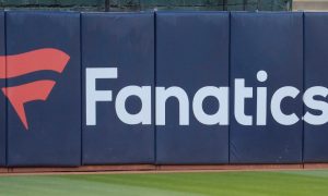 Image of an outfield fence with the Fanatics logo for a story on the company debuting its branded sportsbook and online casino in New Jersey.