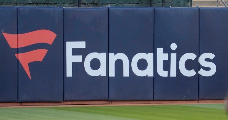 Image of an outfield fence with the Fanatics logo for a story on the company debuting its branded sportsbook and online casino in New Jersey.