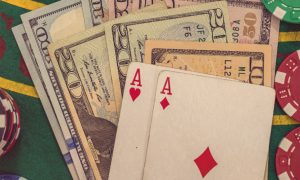 Poker cards on top of money pile for a story on Poker 8 launching in New Jersey.