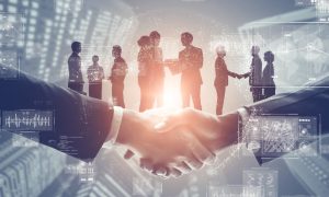 Image of businessmen making a deal for a story on the future of New Jersey sports betting with mergers and acquisitions ongoing.
