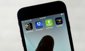 Phone with apps for BetMGM, FanDuel, DraftKings, and WynnBet