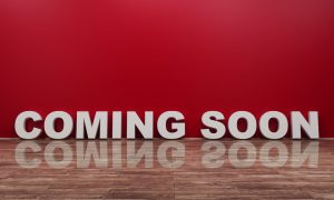 The words coming soon on a marble floor with a red background