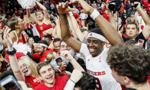 Rutgers basketball players celebrate with fans after a win