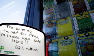 a whiteboard sign in front of a lottery display