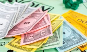a monopoly board with different monopoly dollar currencies