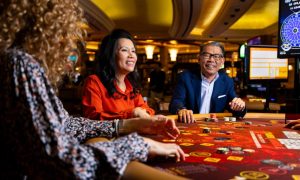 people gathered around a table playing baccarat