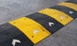 a speed bump in the middle of a driving surface