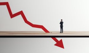 a man staring at an arrow declining through a platform