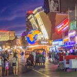 Crowds walk the Atlantic City Boardwalk at night near Ripley's Believe It or Not