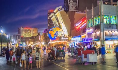 Crowds walk the Atlantic City Boardwalk at night near Ripley's Believe It or Not