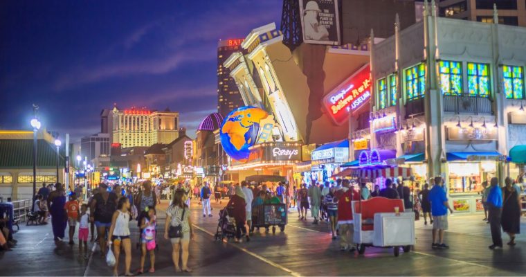 Crowds walk the Atlantic City Boardwalk at night near Ripley's Believe It or Not