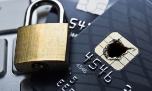 Padlock closing over a credit card with a burned chip