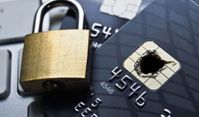 Padlock closing over a credit card with a burned chip