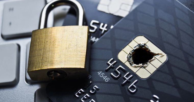 Padlock closing over a credit card with a burned chip