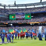Players and flag bearers on the field before a FIFA World Cup match at MetLife Stadium