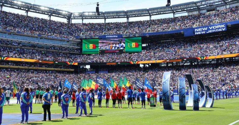 Players and flag bearers on the field before a FIFA World Cup match at MetLife Stadium